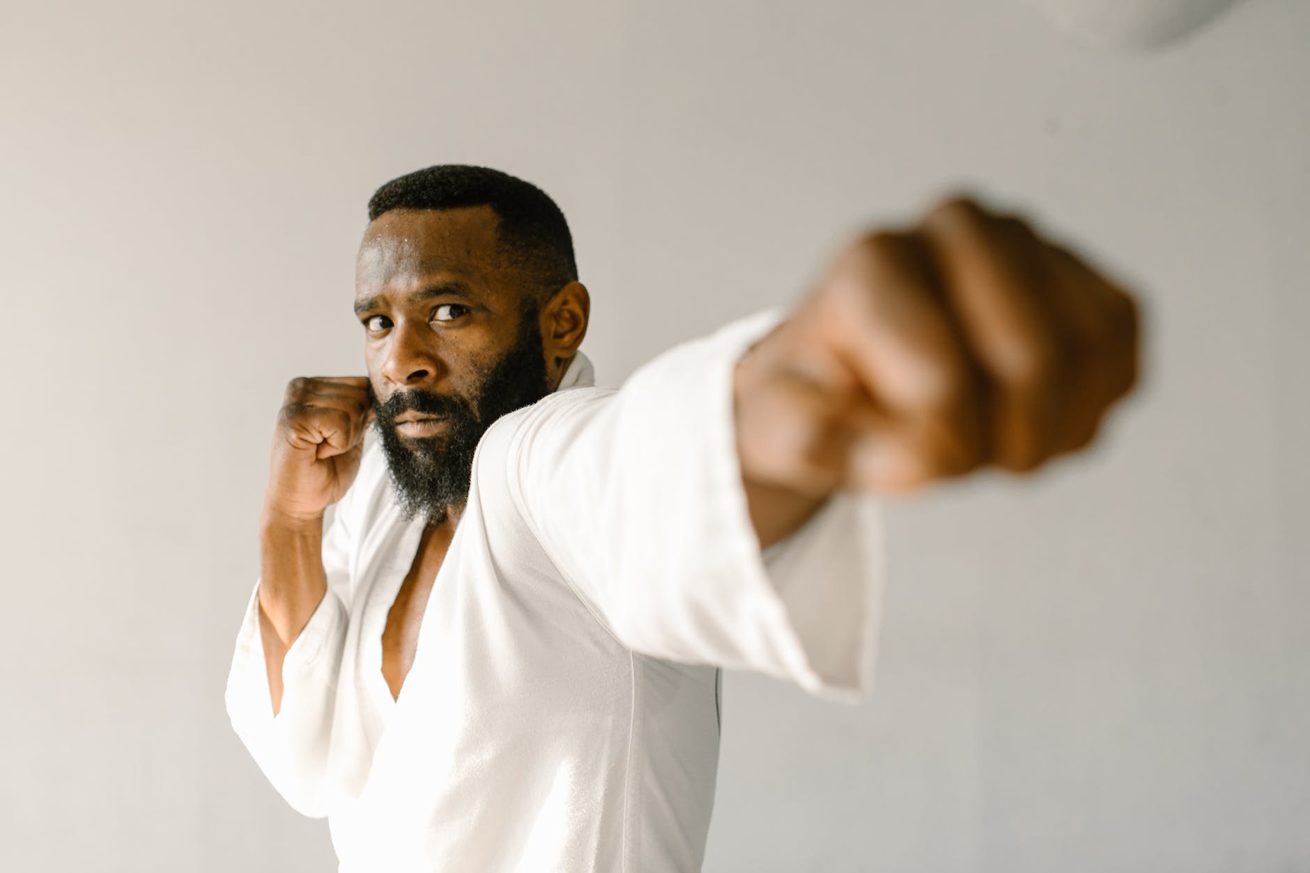 a man punching while protecting his face